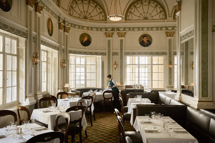 Romanos restaurant inside Simpsons in the Strand, featuring elegant decor and a vibrant dining atmosphere