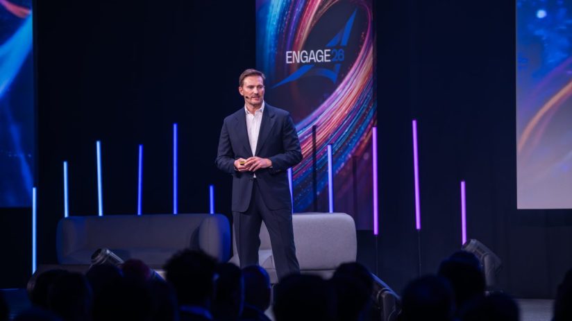 Russell Brown speaking at SCC UK event in London, addressing business leaders on current industry trends and strategies.