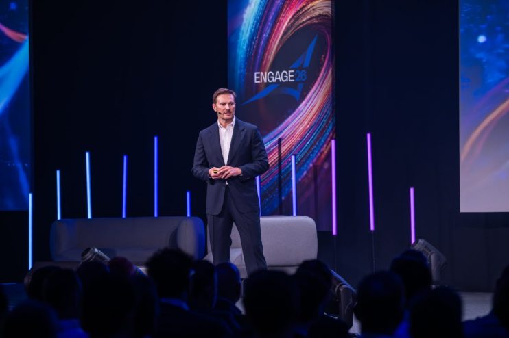 Russell Brown speaking at SCC UK event in London, addressing business leaders on current industry trends and strategies.