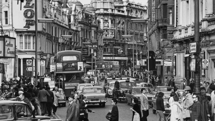 Shaftesbury Avenue West End bustling with 1972 London street life, featuring iconic theaters and vintage cars
