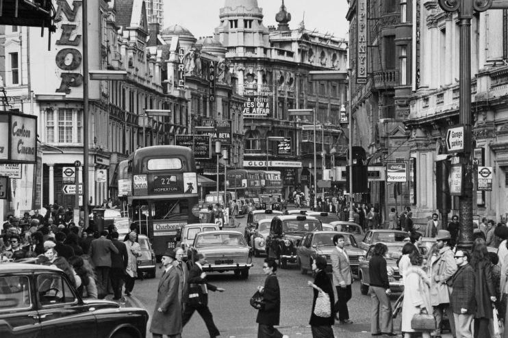 Shaftesbury Avenue West End bustling with 1972 London street life, featuring iconic theaters and vintage cars
