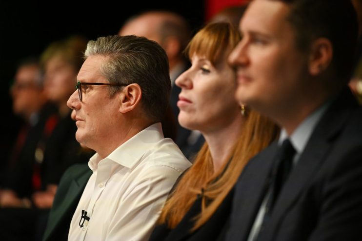 Wes Streeting, Angela Rayner, and Keir Starmer engaged in a discussion at a political event, with a focus on Labour Party ...