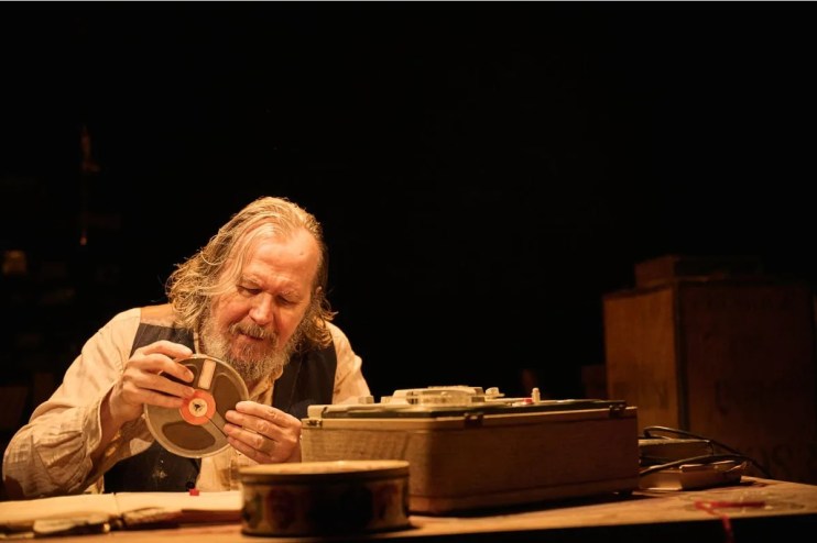 Gary Oldman as Krapp in a theatrical performance of Samuel Becketts Krapps Last Tape, portraying a contemplative scene.