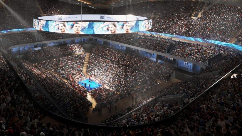 Interior of Londons Colosseum Arena set up for a boxing event, featuring a large ring and tiered seating under bright lights