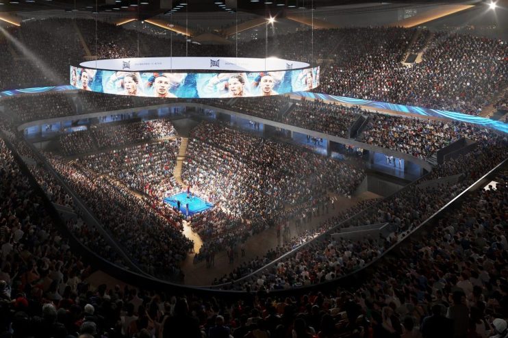 Interior of Londons Colosseum Arena set up for a boxing event, featuring a large ring and tiered seating under bright lights
