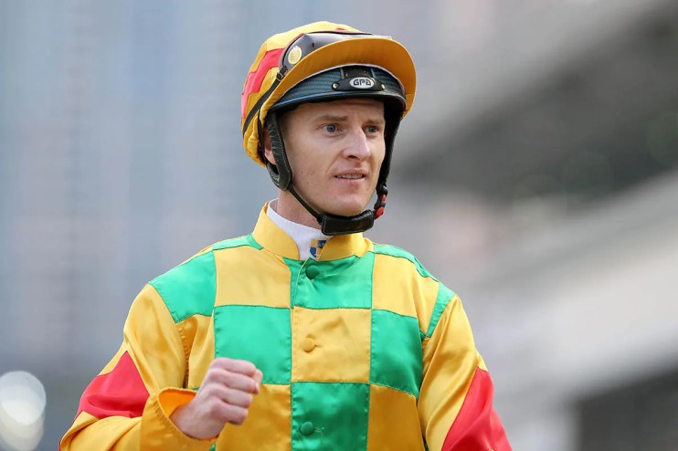 Jockey Zac Purton riding a racehorse during a competitive event, showcasing his skill and determination on the racetrack.