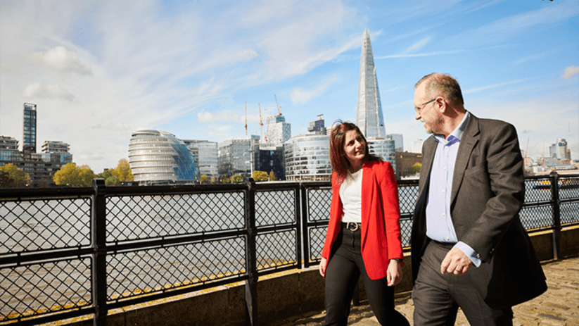 Bayes Business School building in CityAM news article header with modern architecture and bustling city backdrop
