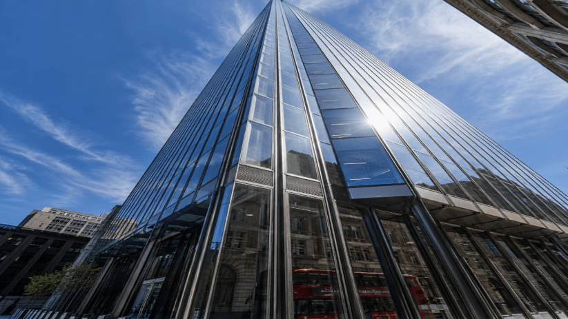 Magnificent skyscraper towering above cityscape, showcasing modern architectural design from base perspective