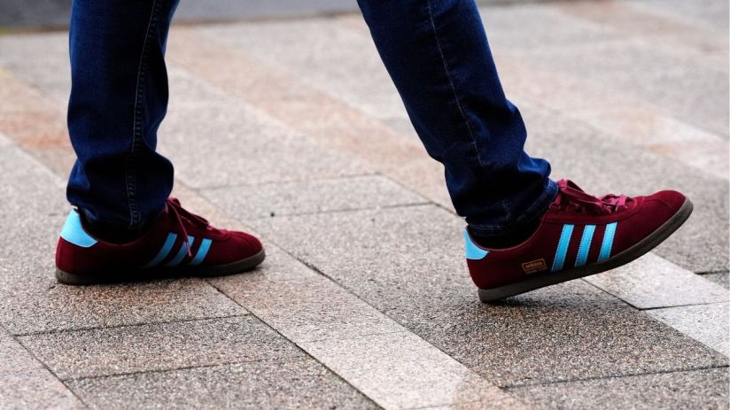Adidas logo displayed prominently on a sleek storefront, representing the brands iconic presence in the sportswear industry.