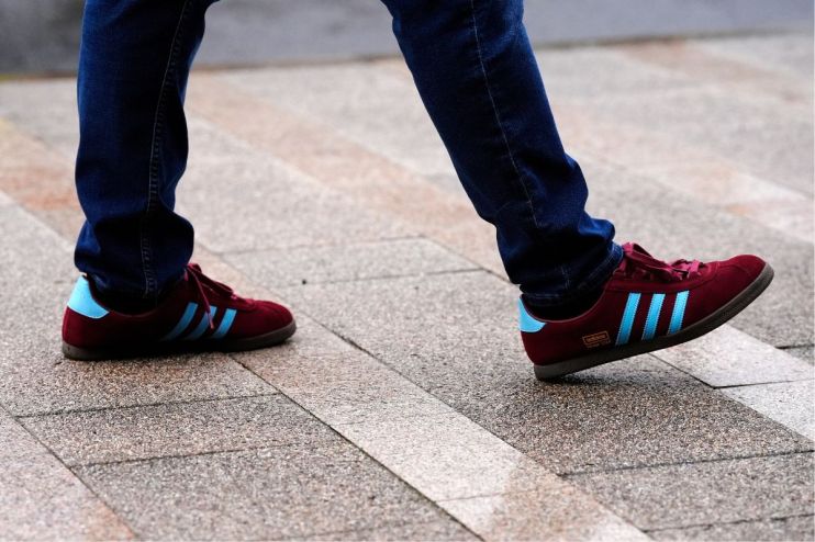 Adidas logo displayed prominently on a sleek storefront, representing the brands iconic presence in the sportswear industry.