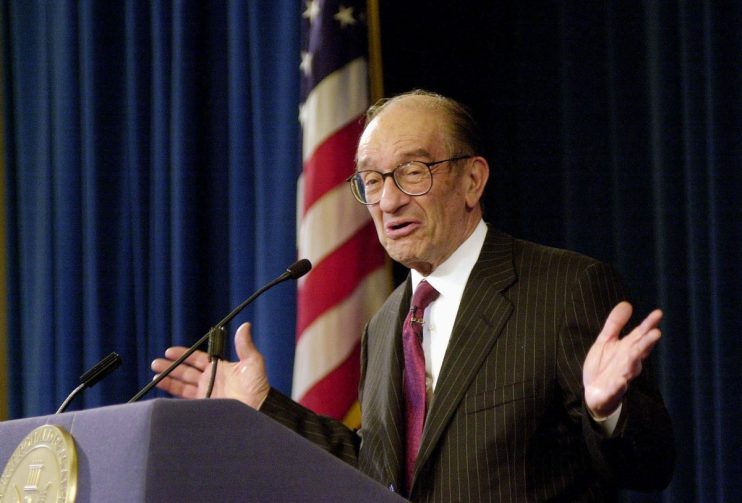 Alan Greenspan speaking at a financial conference, emphasizing economic trends and monetary policy insights in a formal se...