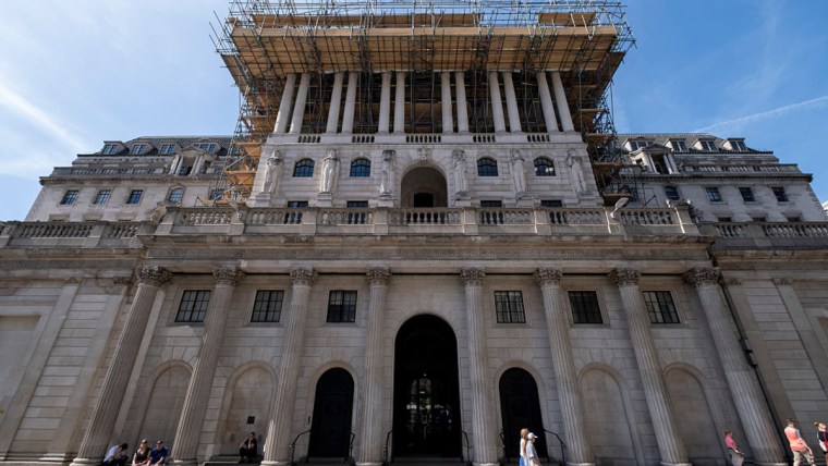 Bank of England headquarters with financial charts overlay, illustrating private credit stress test analysis