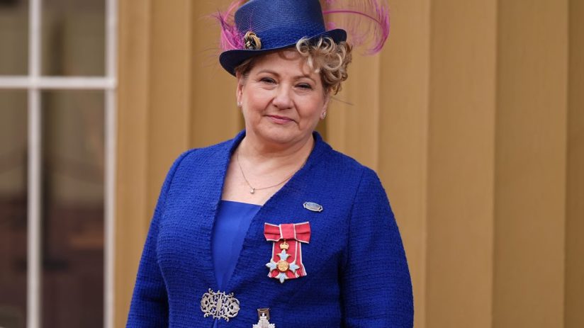 Emily Thornberry addressing media at press conference, wearing a navy blazer, standing at a podium with microphones