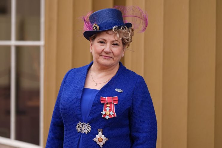 Emily Thornberry addressing media at press conference, wearing a navy blazer, standing at a podium with microphones