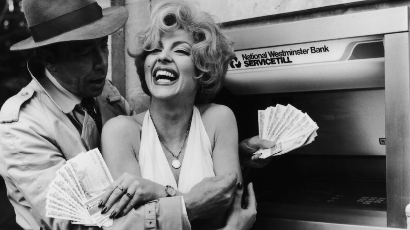 Person fanning a stack of currency notes, symbolizing wealth or financial success, suitable for business news context.