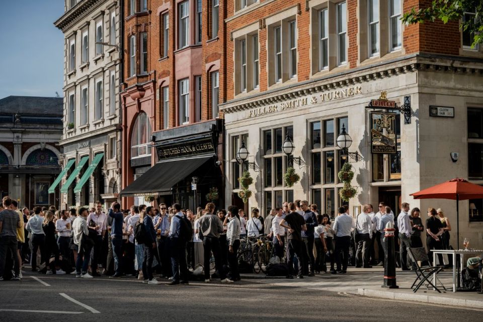 Fullers brewing equipment and staff showcasing traditional beer-making process in a bustling brewery environment