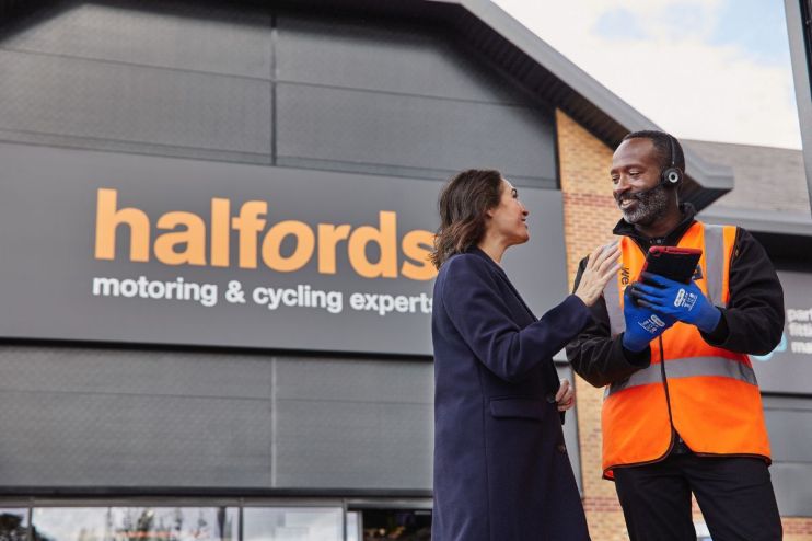 Halfords store exterior showcasing automotive and cycling products, highlighting retail branding and customer access points