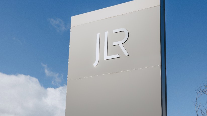JLR logo prominently displayed in an automotive business setting, highlighting the companys brand presence and identity