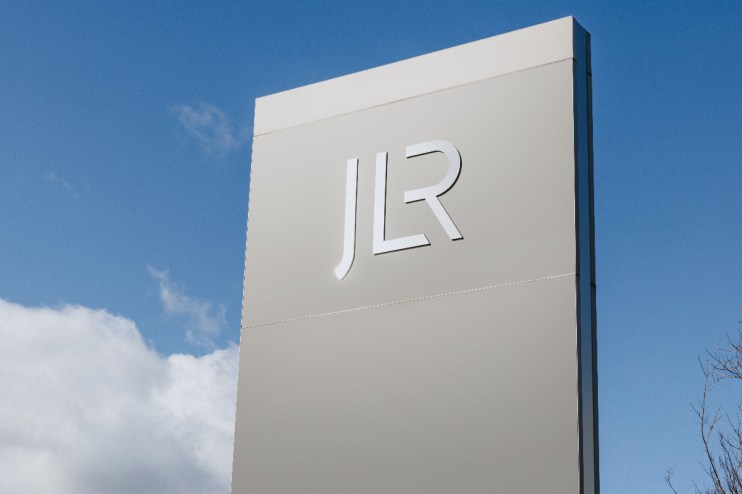 JLR logo prominently displayed in an automotive business setting, highlighting the companys brand presence and identity