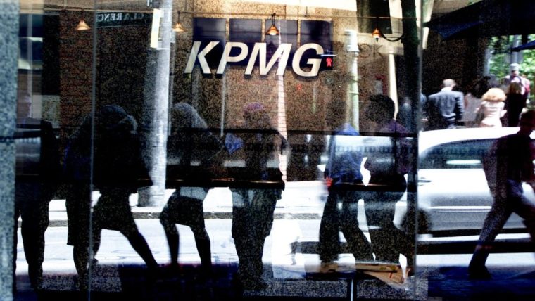 KPMG Australia office building exterior with modern glass architecture and corporate signage in a bustling business district.