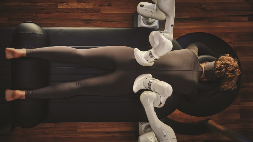 AI-powered robotic massage at Qua Baths and Spa in Caesars Palace, featuring two large robot arms in a treatment room.