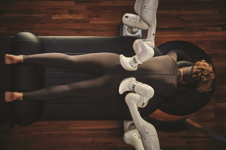 AI-powered robotic massage at Qua Baths and Spa in Caesars Palace, featuring two large robot arms in a treatment room.