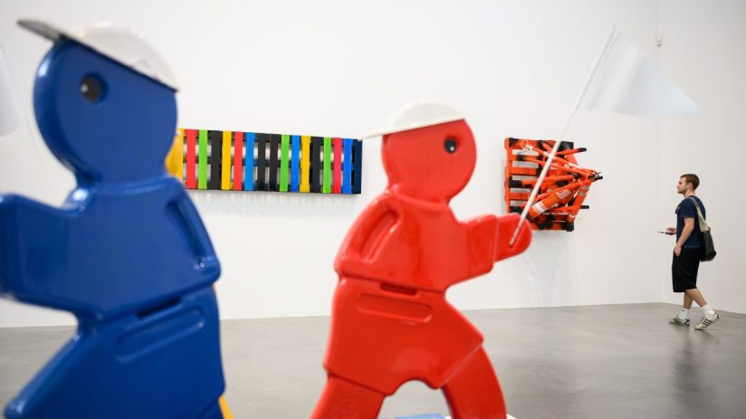 Contemporary art pieces displayed at a London exhibit showcasing diverse and innovative works in a vibrant gallery setting