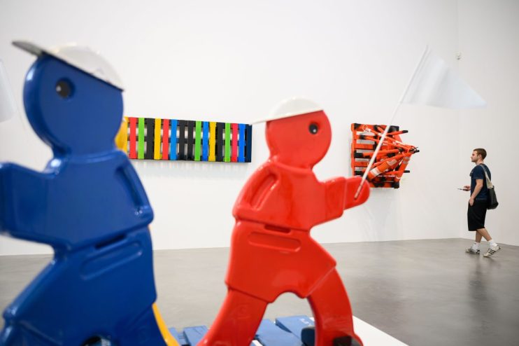 Contemporary art pieces displayed at a London exhibit showcasing diverse and innovative works in a vibrant gallery setting