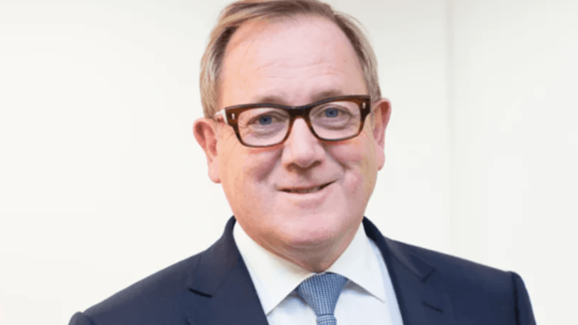 Mark Dixon, CEO of IWG, in a business setting discussing flexible workspace solutions and future industry trends.