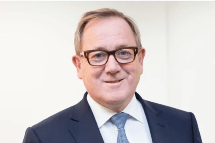 Mark Dixon, CEO of IWG, in a business setting discussing flexible workspace solutions and future industry trends.