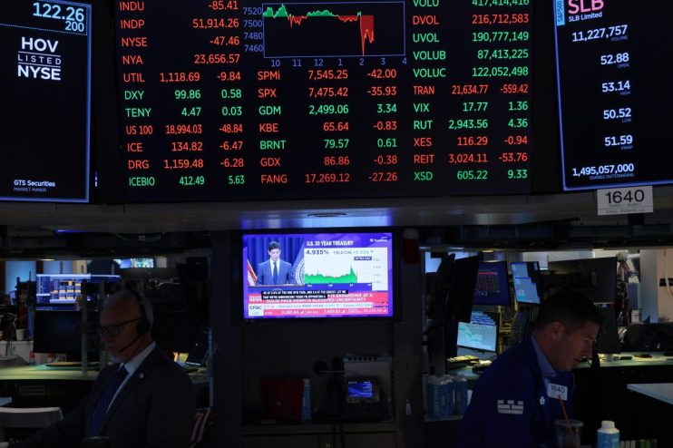 NYSE trading floor bustling with activity as traders monitor market trends and stock performance on electronic displays