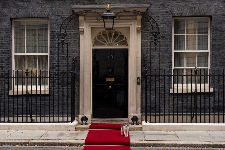 Number 10 Downing Street entrance with iconic black door and brass letterbox, symbolizing UK Prime Ministers official resi...