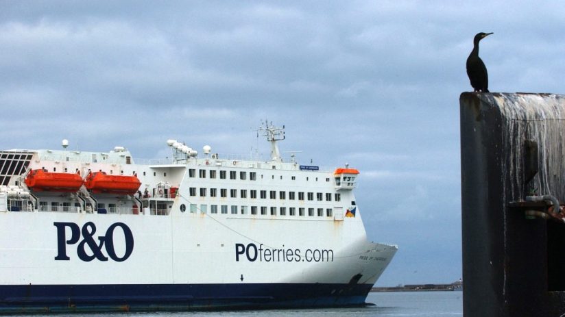 PO Ferries vessel docked at port under a clear sky, showcasing maritime transport and travel industry operations.