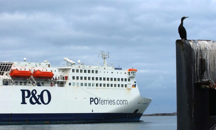 PO Ferries vessel docked at port under a clear sky, showcasing maritime transport and travel industry operations.