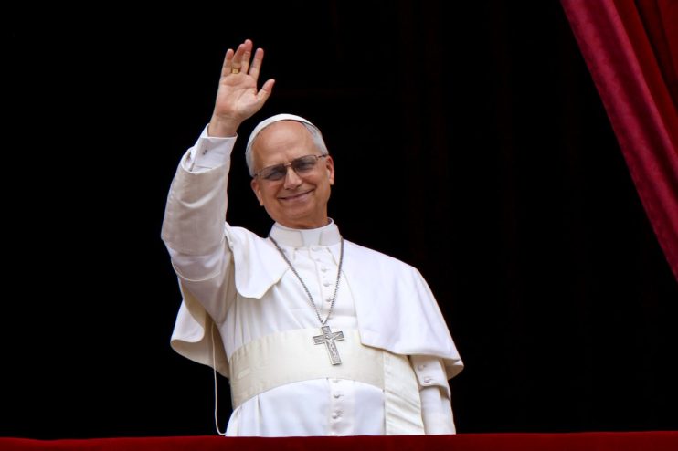 Pope Leo depicted in traditional papal attire delivering a speech at the Vatican, surrounded by historical architecture.