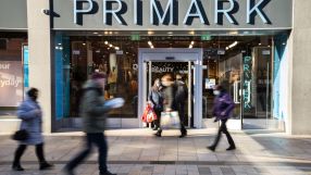 Primark store exterior showcasing modern architectural design and branded signage on a bustling shopping street.