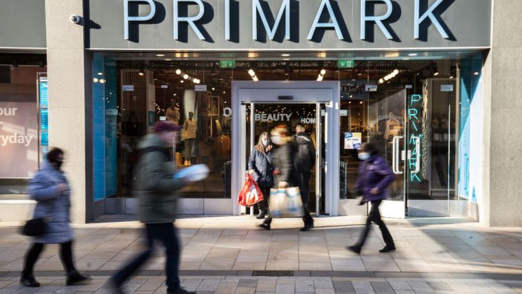 Primark store exterior showcasing modern architectural design and branded signage on a bustling shopping street.