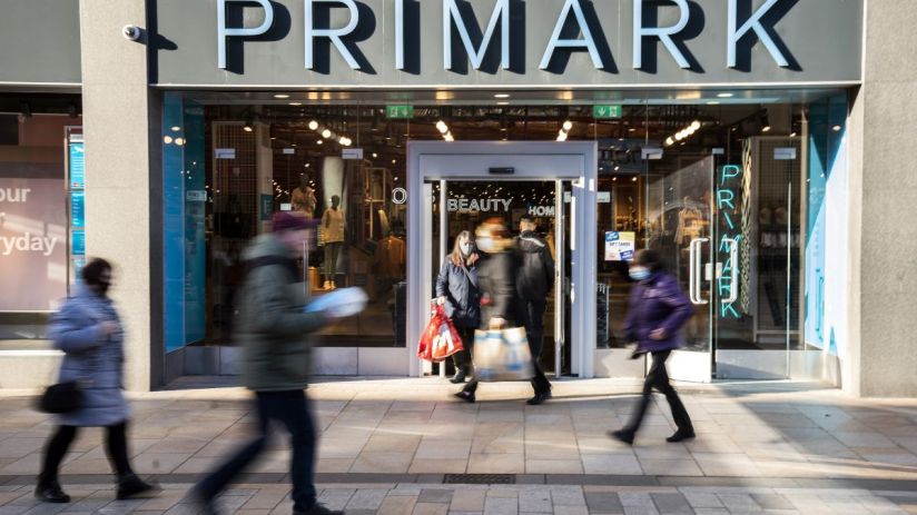 Primark store exterior showcasing modern architectural design and branded signage on a bustling shopping street.