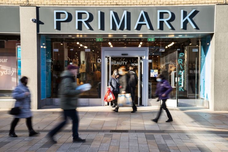 Primark store exterior showcasing modern architectural design and branded signage on a bustling shopping street.