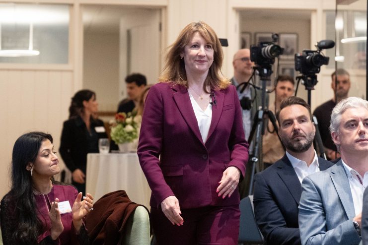 Rachel Reeves discusses AI adoption for economic growth at UK business conference podium.