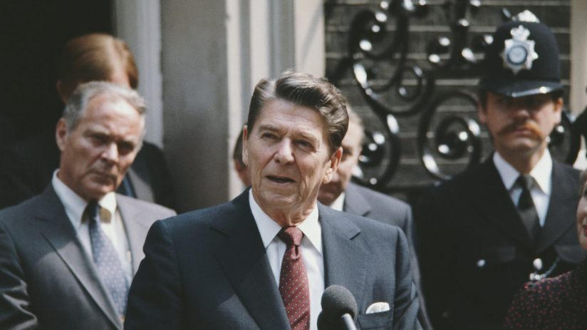 Ronald Reagan delivering a speech at the White House podium, emphasizing leadership and political impact during his presid...