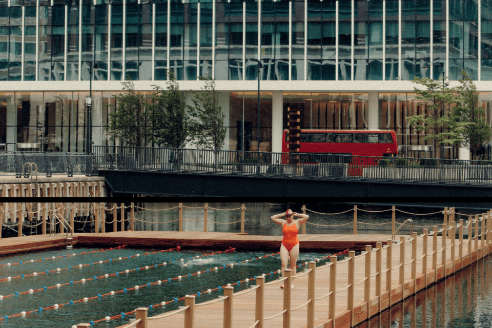 Canary Wharf sea lanes bustling with commercial vessels against a cityscape backdrop, highlighting maritime activity