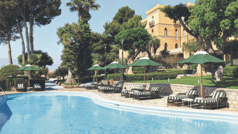 Scenic view of Sicilian coastline with historic architecture and vibrant Mediterranean landscape in Italy