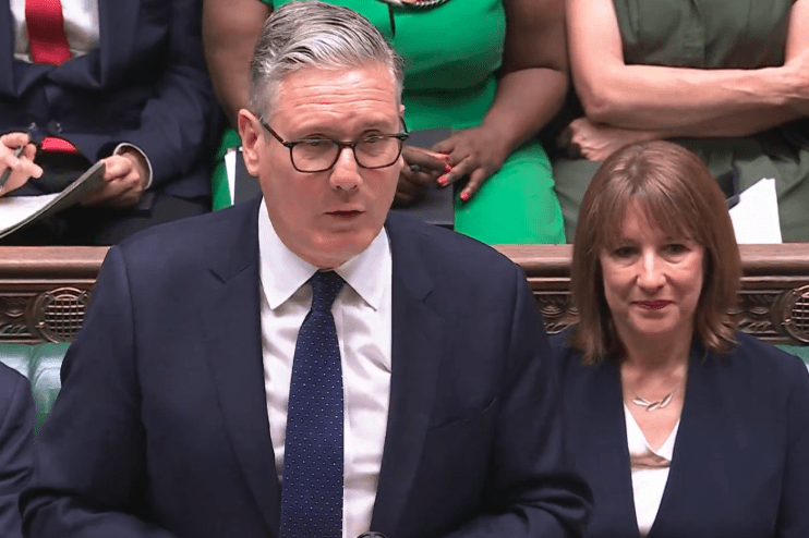 Keir Starmer speaking passionately at Prime Ministers Questions in the UK Parliament chamber, addressing government policies.