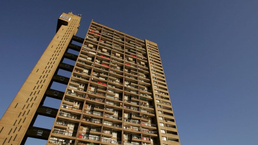 Trellick Tower UK council estate architecture, highlighting its iconic brutalist design against a clear sky backdrop.