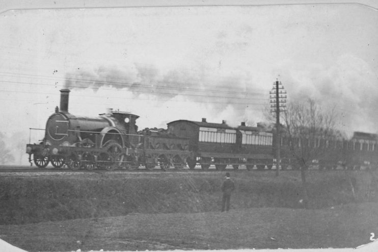 Victorian Express train journey showcasing historic locomotive and passengers in period attire for a scenic countryside ride