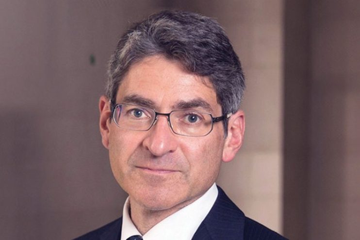 Jonathan Haskel speaking at a business conference, wearing a suit and tie with a focused expression, emphasizing economic ...