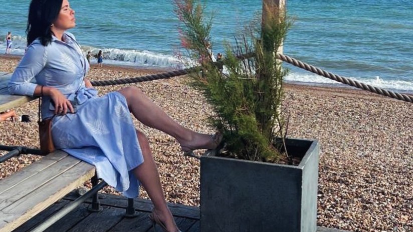 Libby Brodie enjoying wine at a seaside hotel, capturing the essence of luxury and relaxation by the ocean.