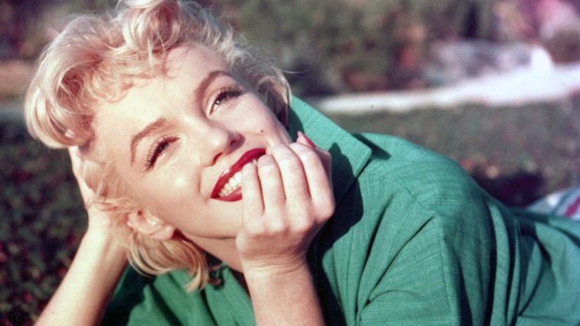 Marilyn Monroe posing in an iconic white dress, capturing her timeless elegance and classic Hollywood glamor.