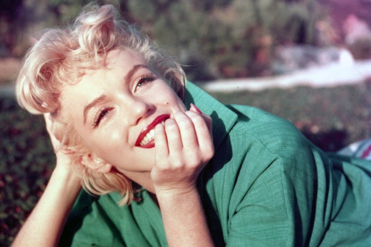 Marilyn Monroe posing in an iconic white dress, capturing her timeless elegance and classic Hollywood glamor.